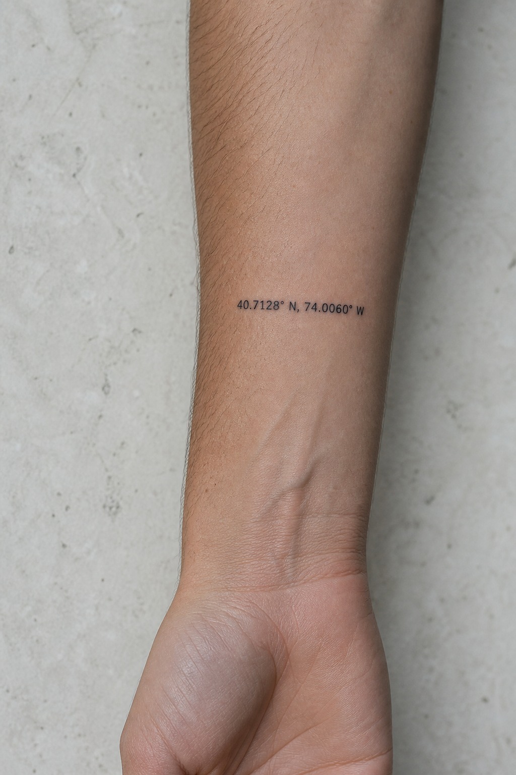 Minimalist geographical coordinates forearm tattoo