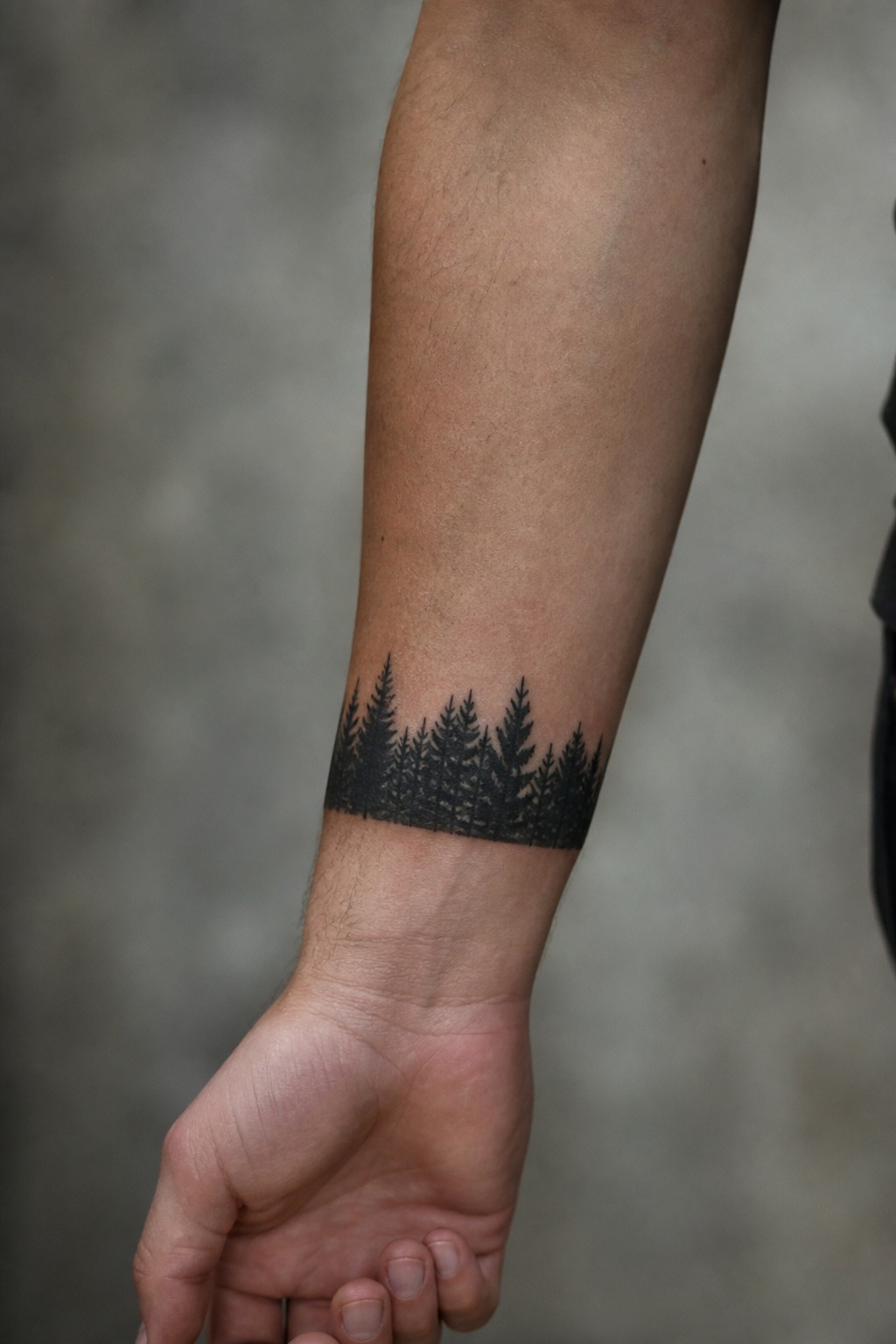 Pine tree horizon forest silhouette forearm tattoo