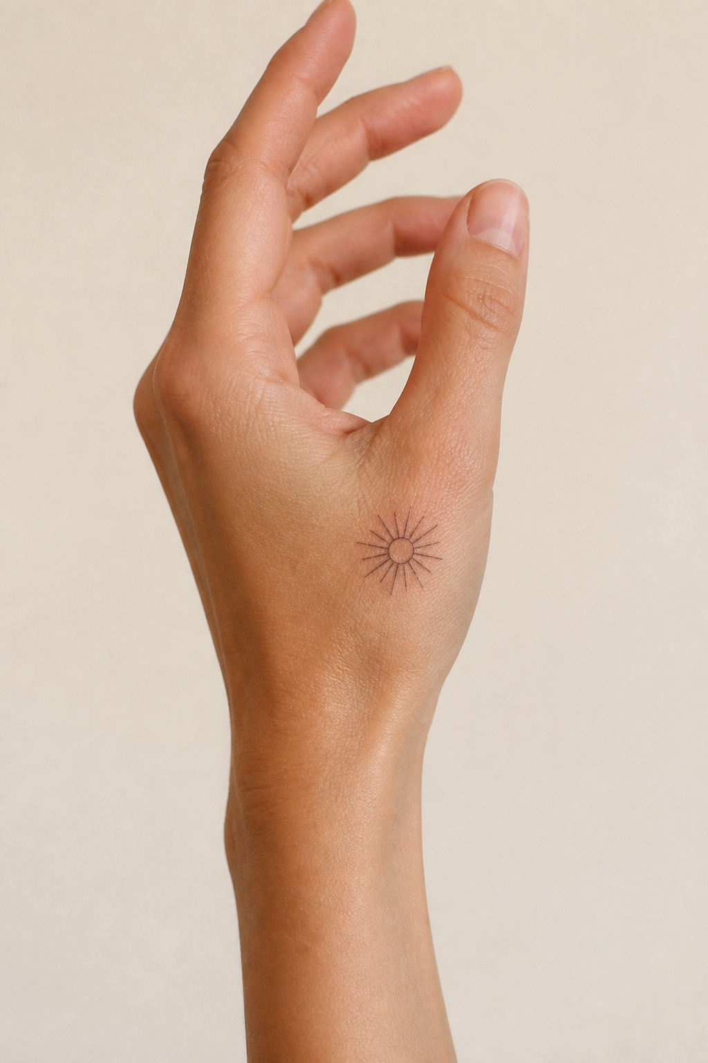 Minimalist sunburst outer hand accent tattoo
