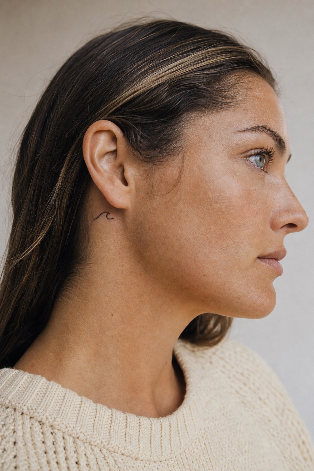 Minimalist wave behind the ear tattoo for women
