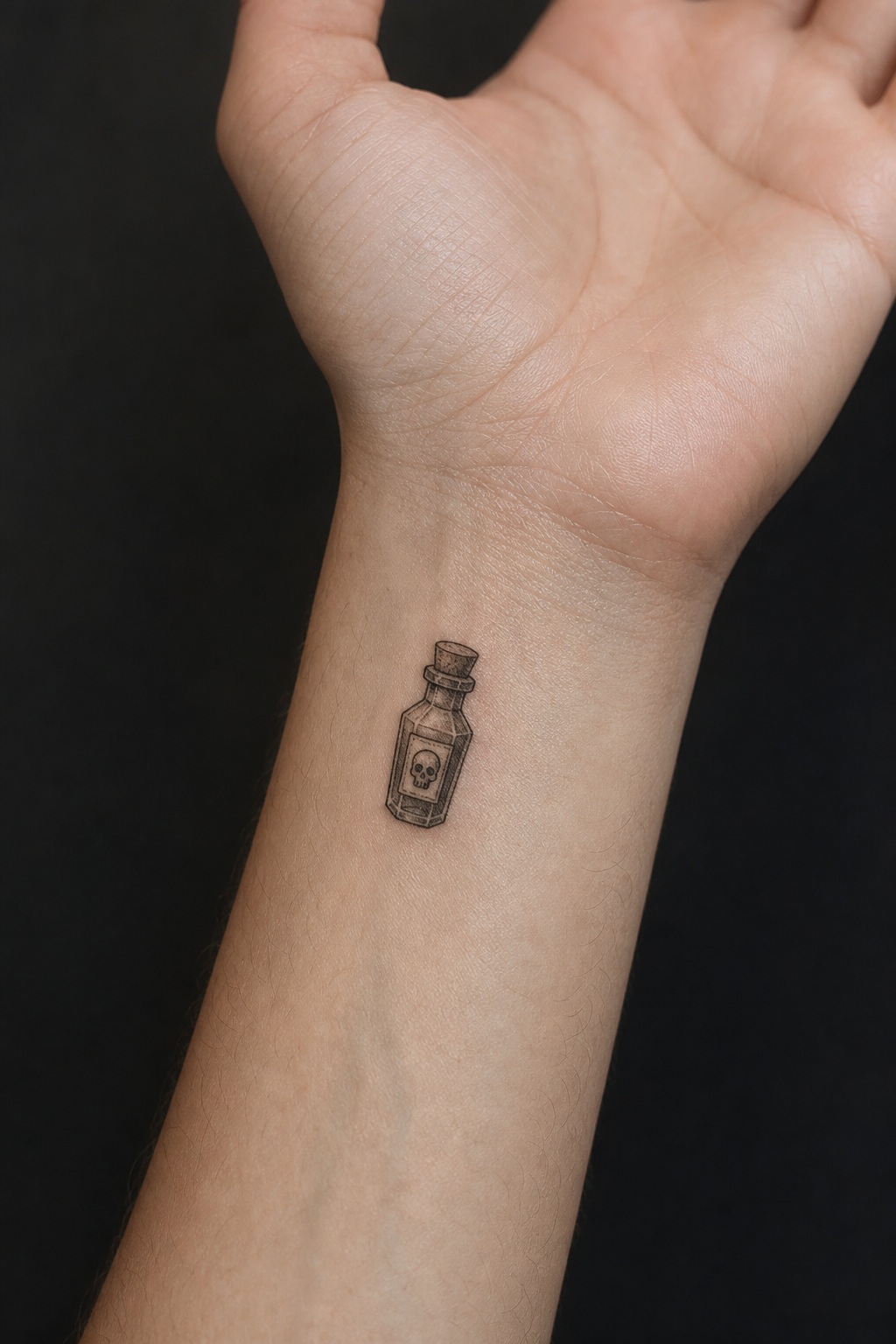 Micro poison bottle inner wrist tattoo