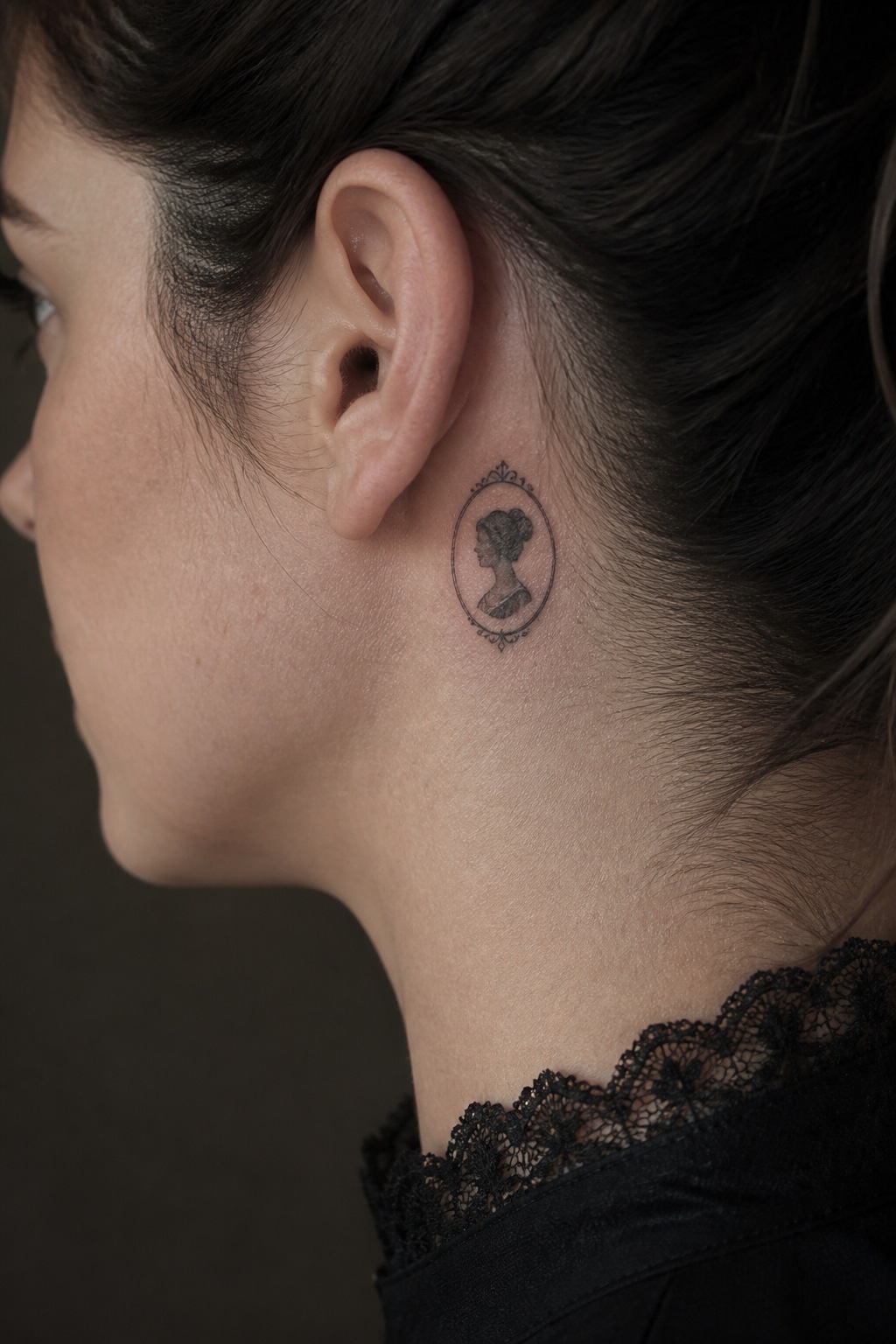 Fine line micro cameo silhouette behind the ear tattoo