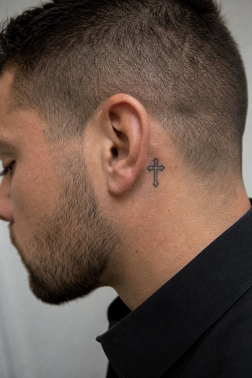 Behind the ear micro gothic cross tattoo for men