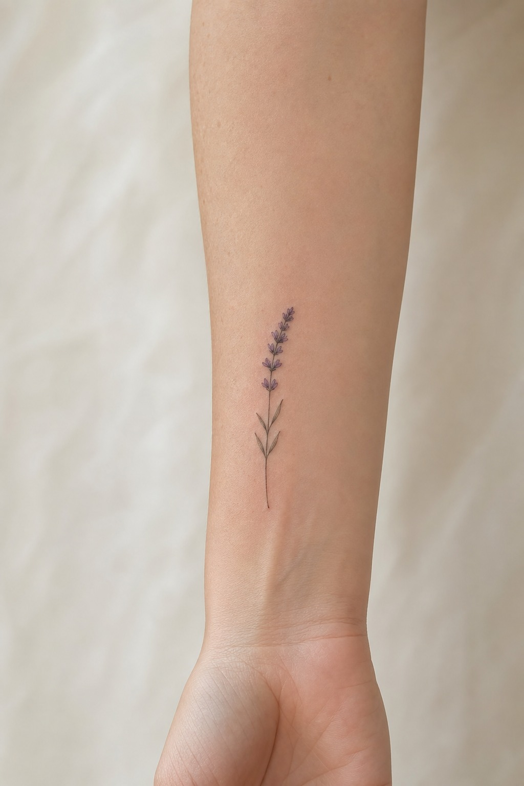 Micro botanical lavender sprig forearm tattoo