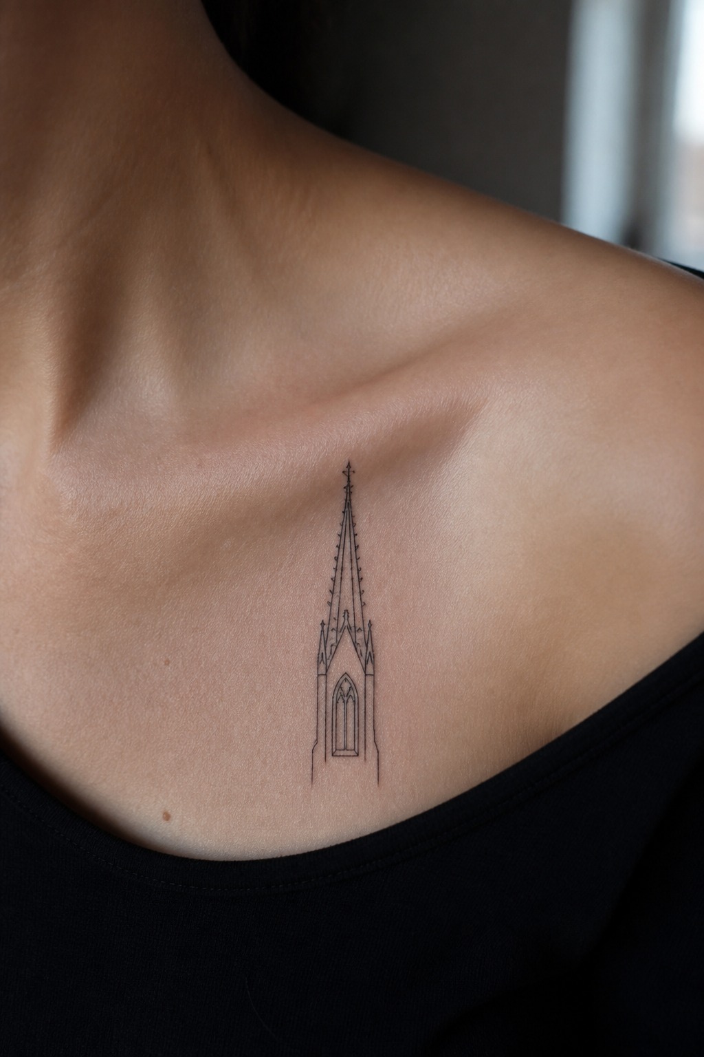 Single line gothic spire collarbone tattoo