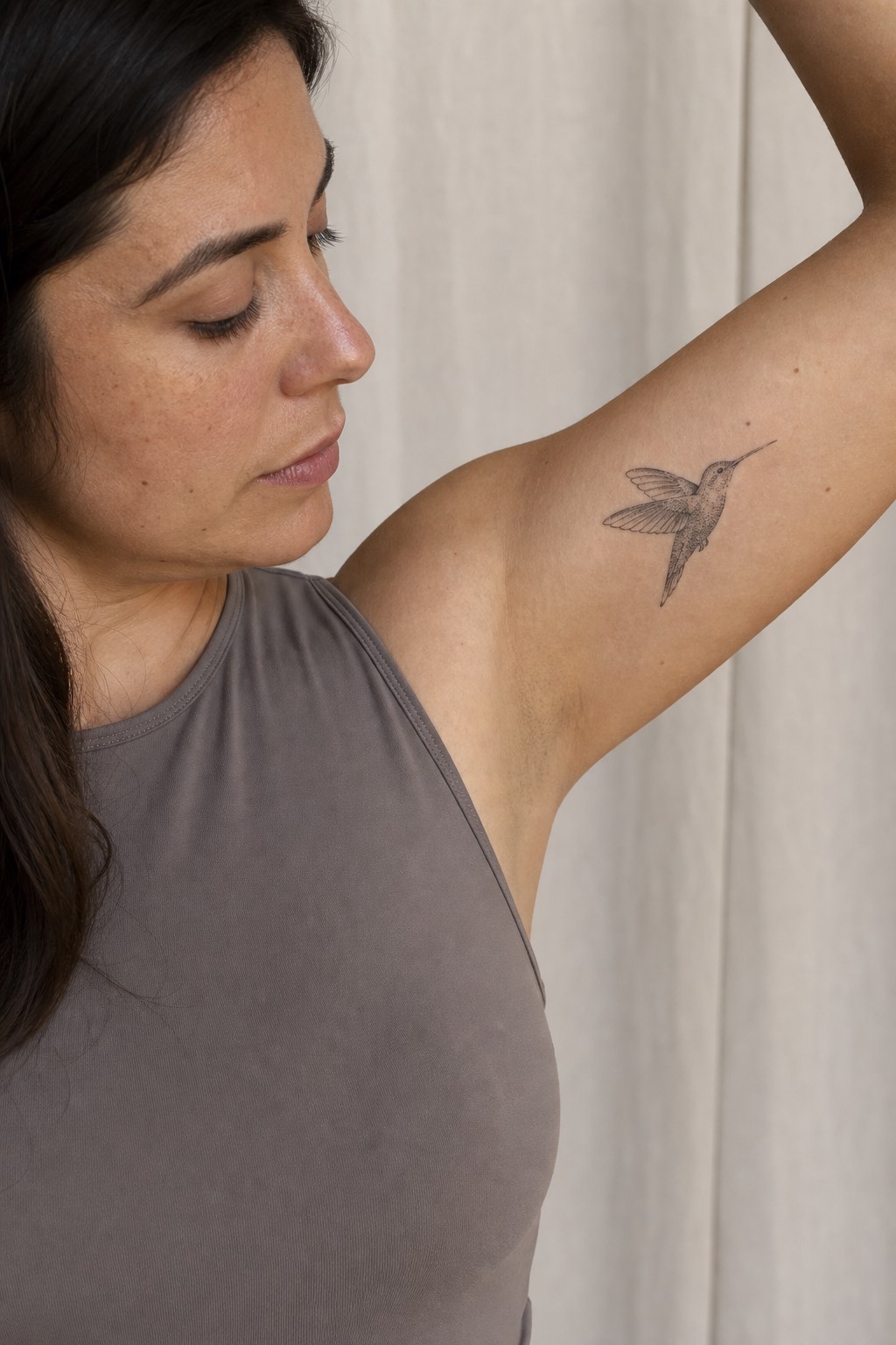 Fine line hummingbird bicep flight tattoo for women