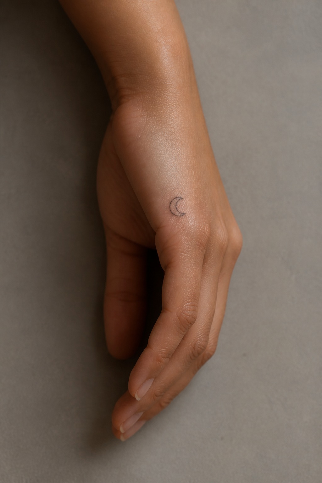Single line crescent moon outer hand tattoo for women