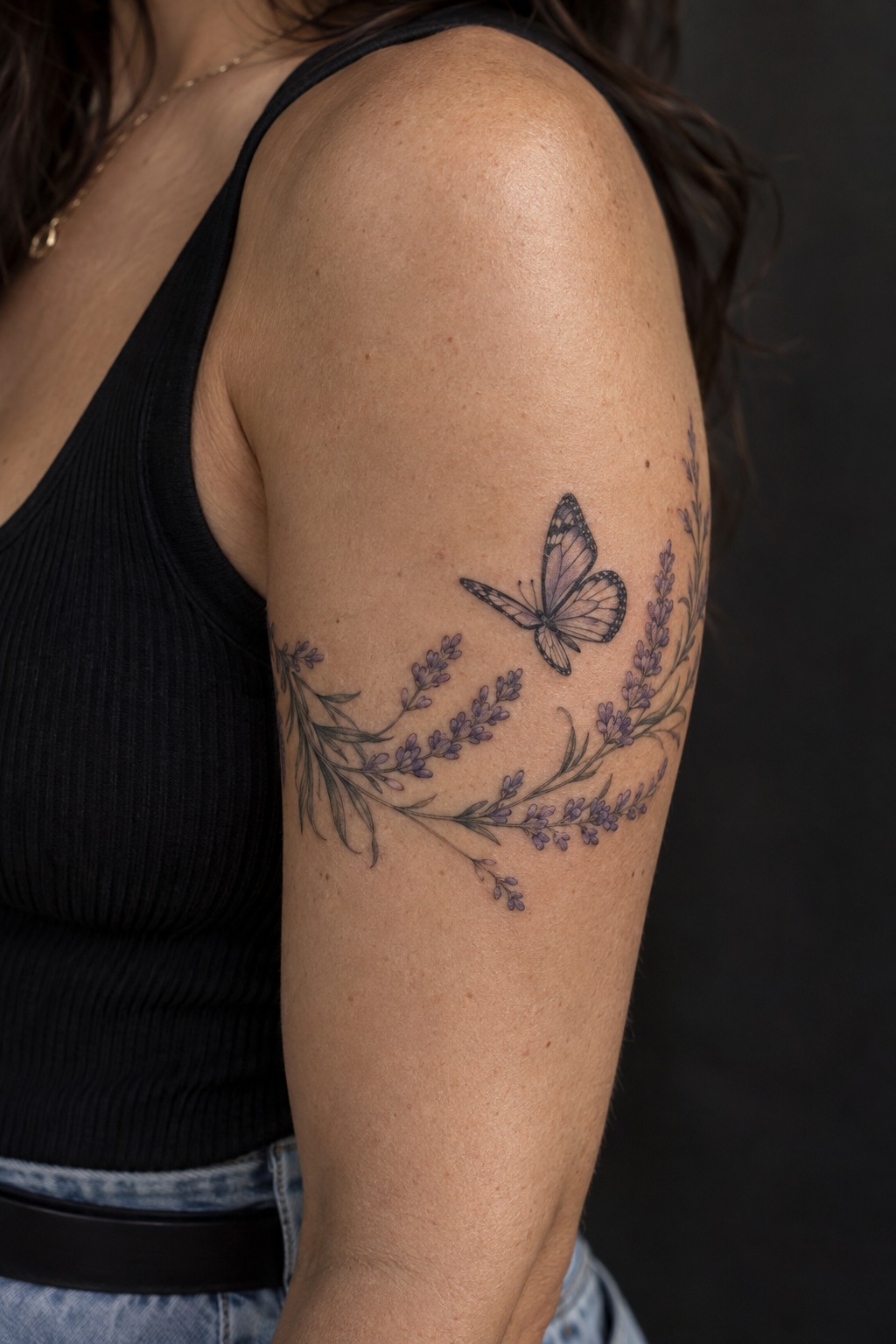 Lavender sprig and flying butterfly bicep wrap tattoo