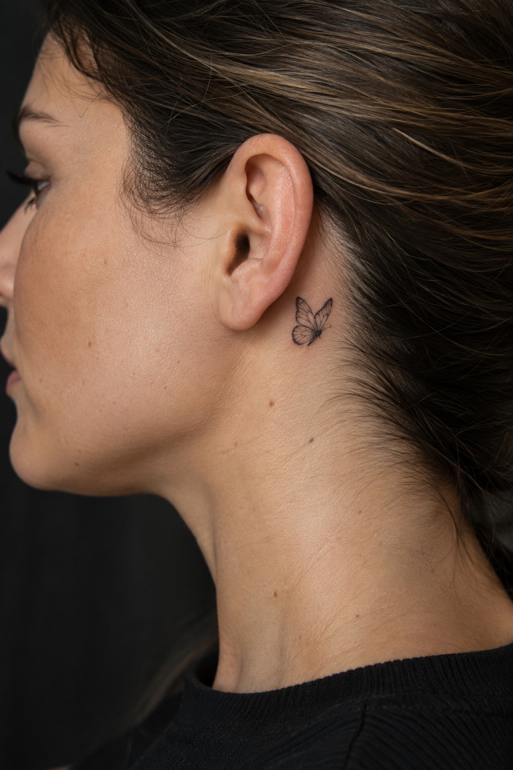 Micro butterfly behind the ear accent tattoo