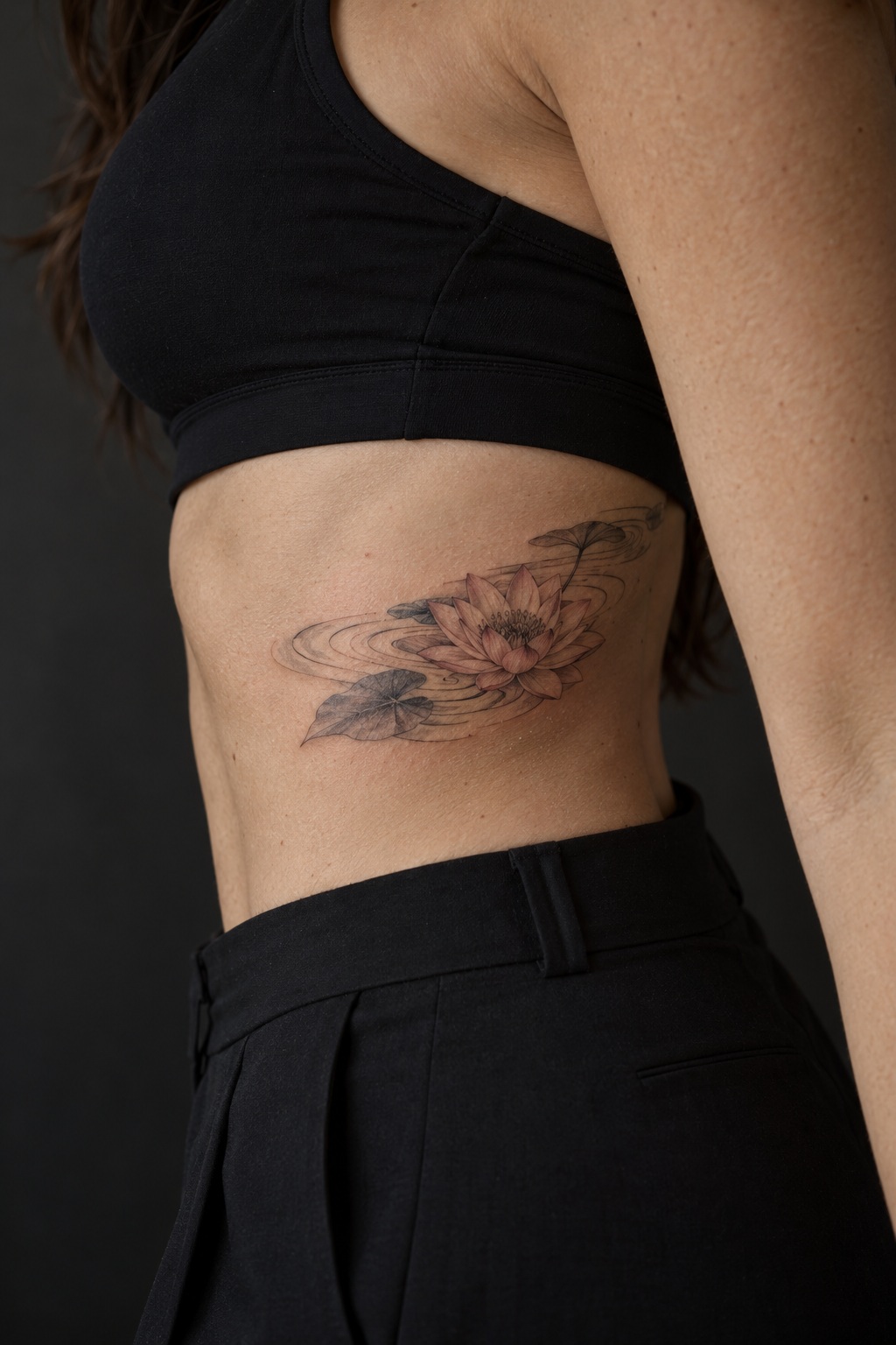 Water lily and fluid ripple rib accent tattoo