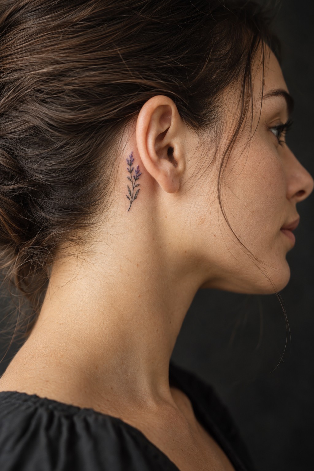 Micro lavender sprig behind the ear tattoo